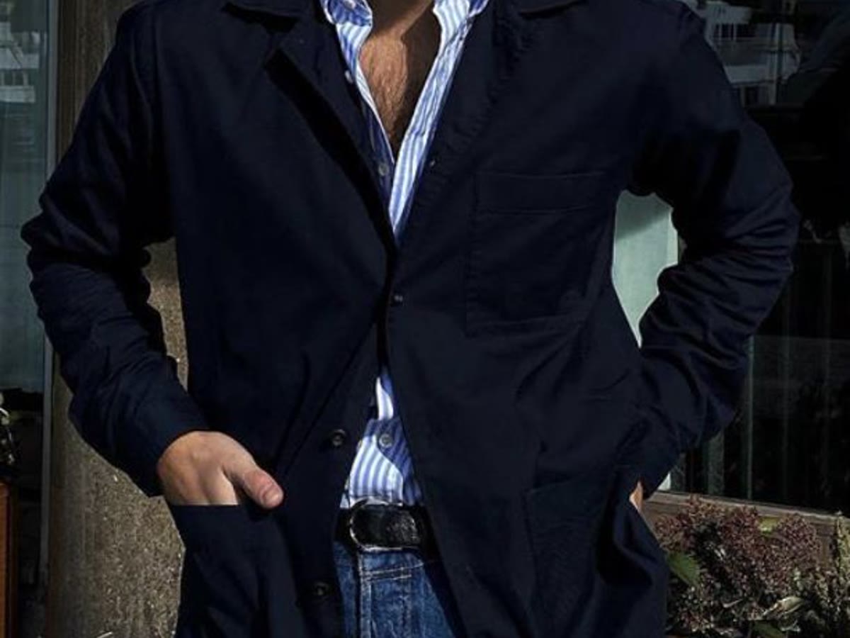 Man in a navy blazer and blue shirt for a dress shirt guide