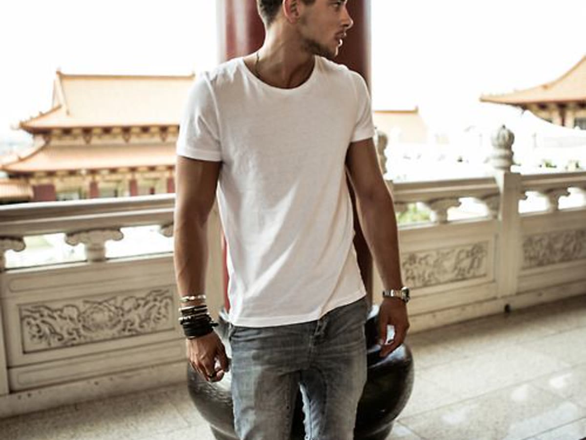 Man in a clean white T-shirt and jeans for a men's basics guide
