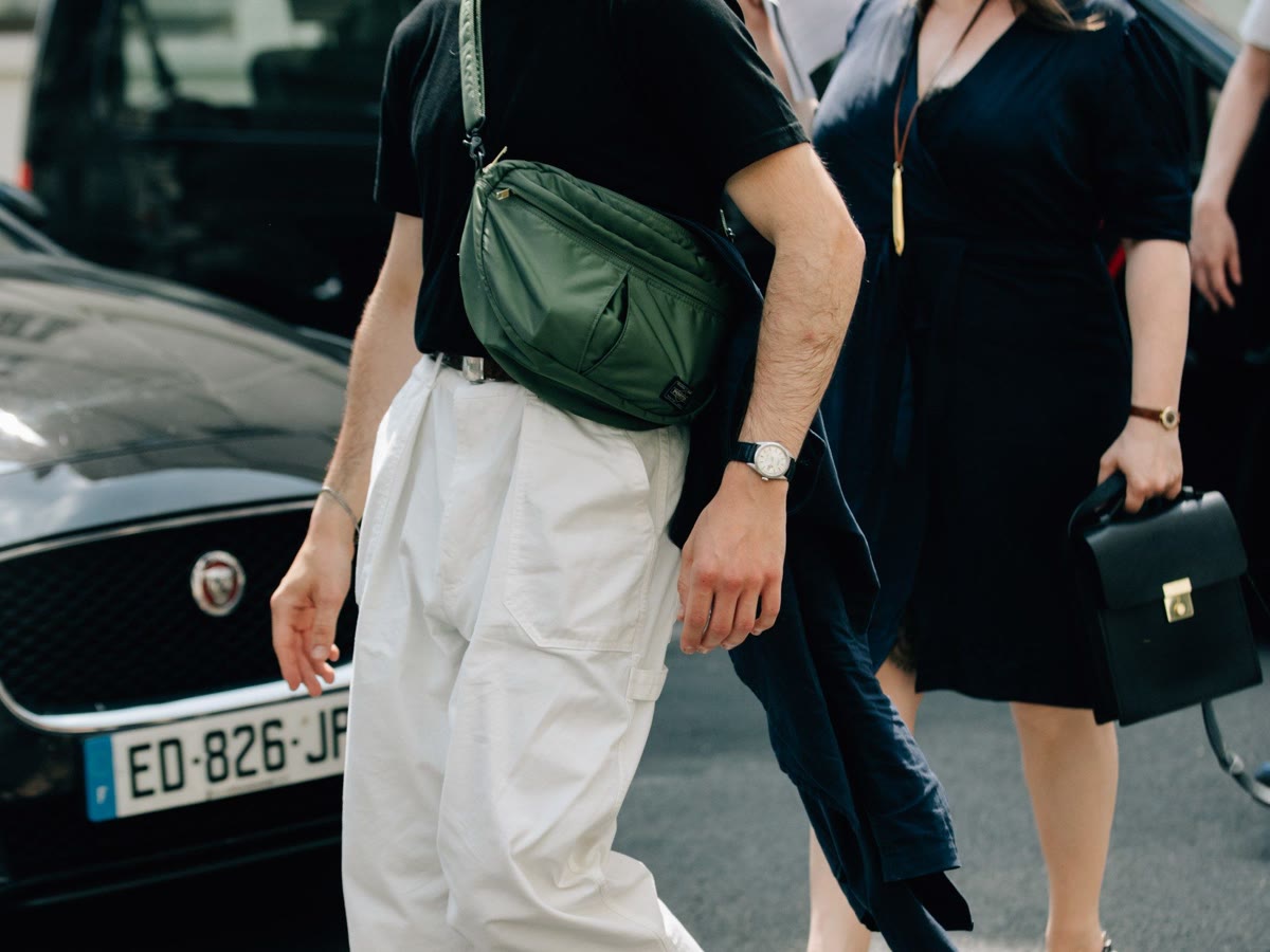 Man carrying a refined crossbody bag for a men's accessories guide
