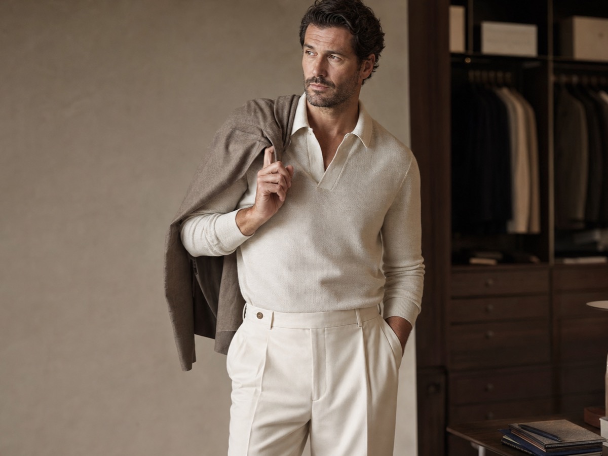 Man in refined neutral knitwear and tailored trousers during an online styling wardrobe review